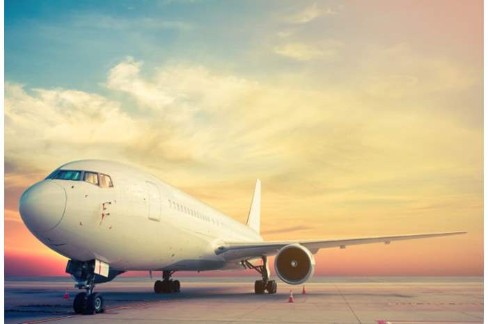 airplane-parking-with-sunset_37328-3