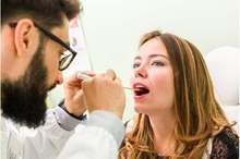 woman-with-green-tongue-being-inspected-by-dentist-or-doctor